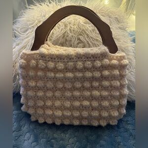 Adorable handcrafted Crocheted handbag with wooden handle.